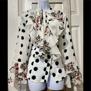 New w/minor flaws, white multi color blouse with ruffles on sleeve and collar